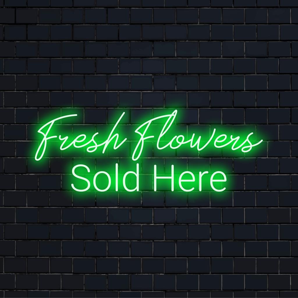 Brilhante e convidativo, este letreiro de LED neon feito sob medida diz "Flores frescas vendidas aqui" para uma exibição de varejo atraente.