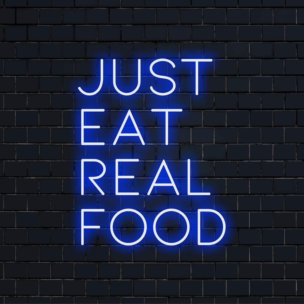 Letreiro de neon vibrante com a mensagem Just Eat Real Food em luzes LED brilhantes; perfeito para decoração moderna e entusiastas do bem-estar.