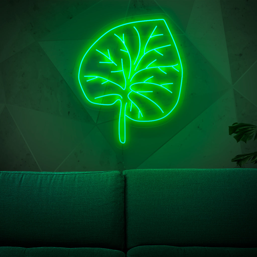 Um letreiro de neon iluminado com uma folha verde vibrante, adicionando um toque de beleza inspirada na natureza e charme orgânico a qualquer espaço