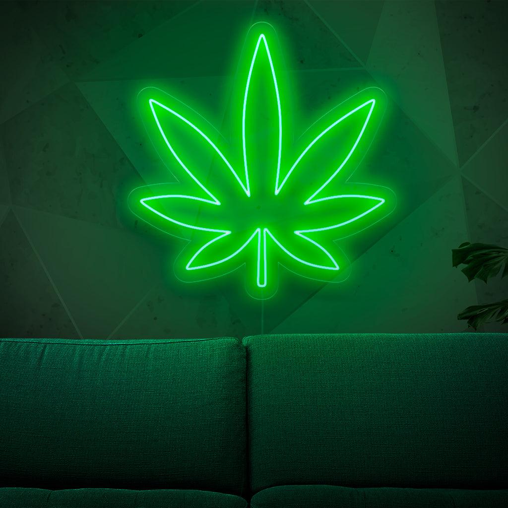Um letreiro de neon iluminado com uma folha de maconha, simbolizando a cultura da cannabis e da erva, adicionando um toque de charme herbal a qualquer espaço