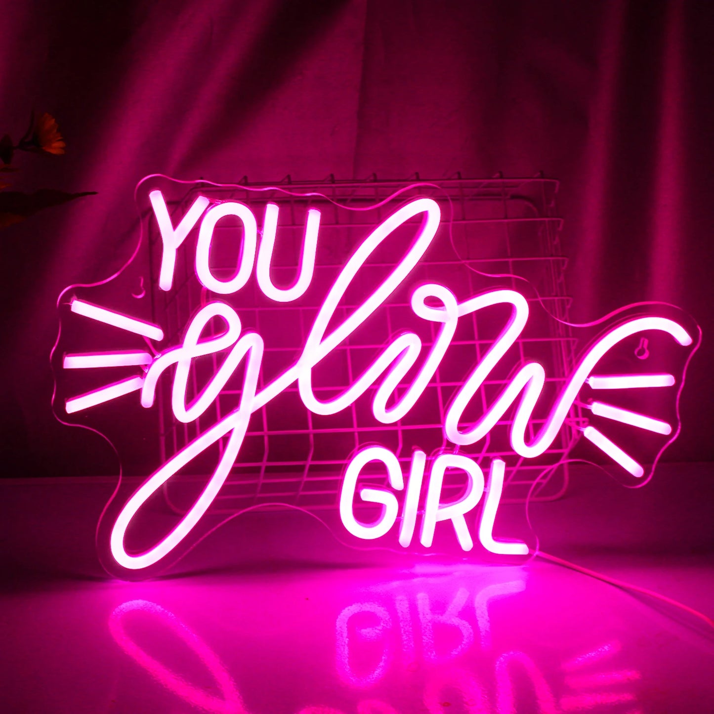 A imagem apresenta uma vibrante placa de LED neon que diz "You Glow Girl" em uma fonte cursiva estilosa.
