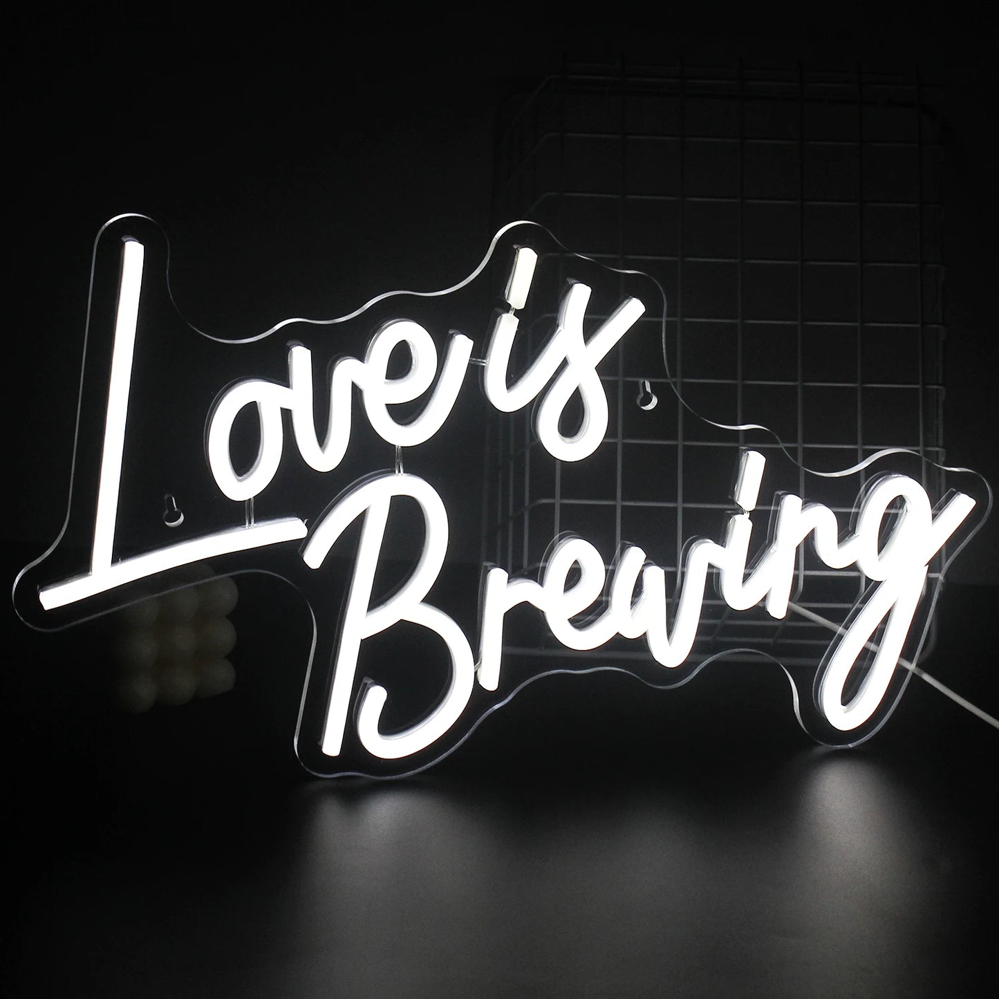 Uma vibrante placa de LED neon exibindo a frase "Love is Breaking" (O amor está se desfazendo), com tipografia moderna e ousada.