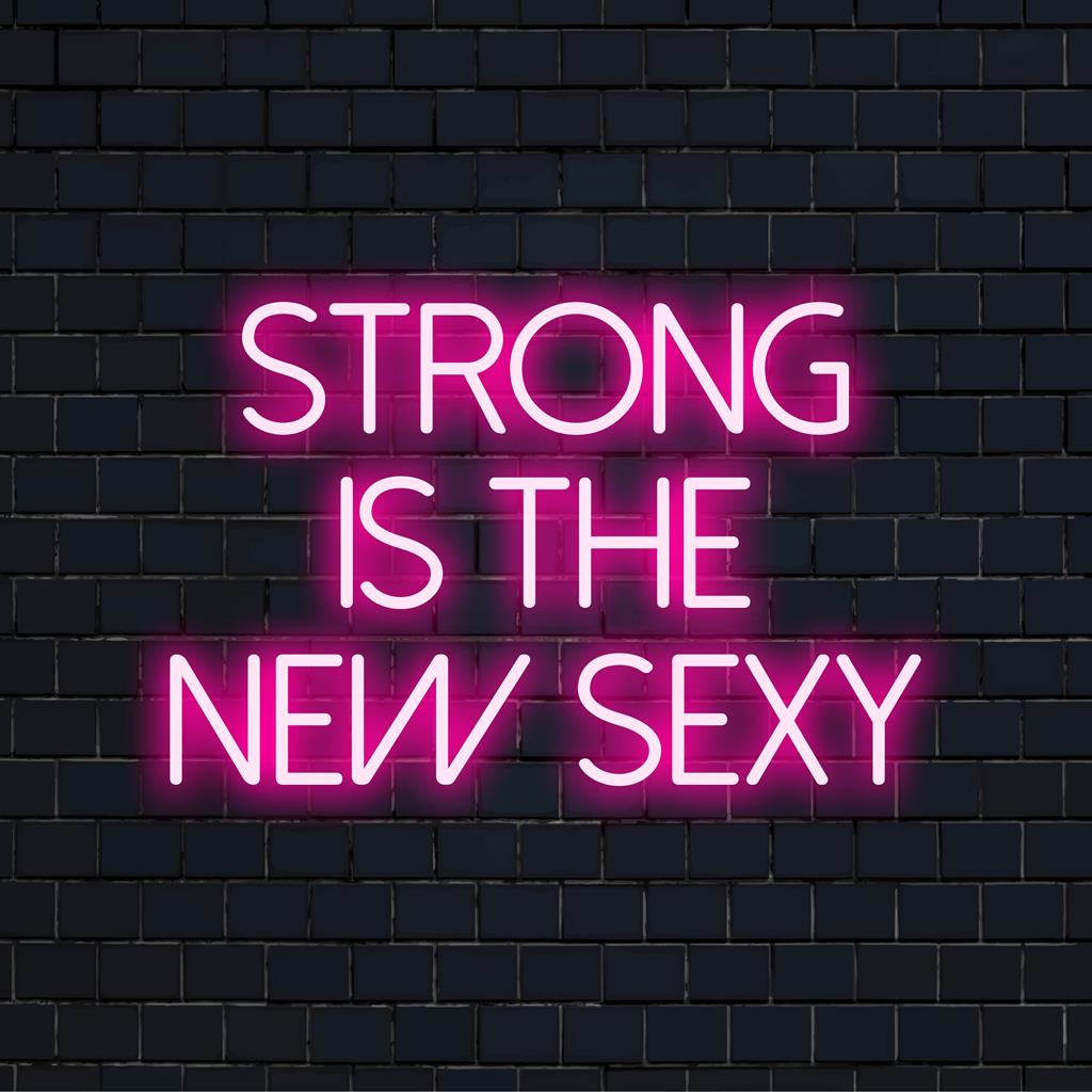 Placa de neon de LED com a frase Strong Is The New Sexy; arte de parede vibrante e motivacional iluminada em cores brilhantes.