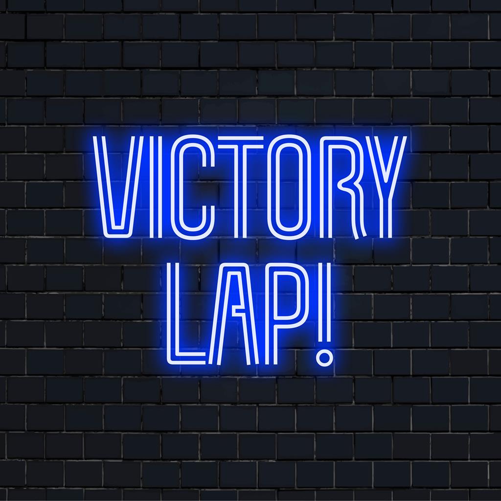 Placa de neon personalizada com a frase Victory Lap! em cores brilhantes, ilumina qualquer espaço, perfeita como decoração neon personalizada.