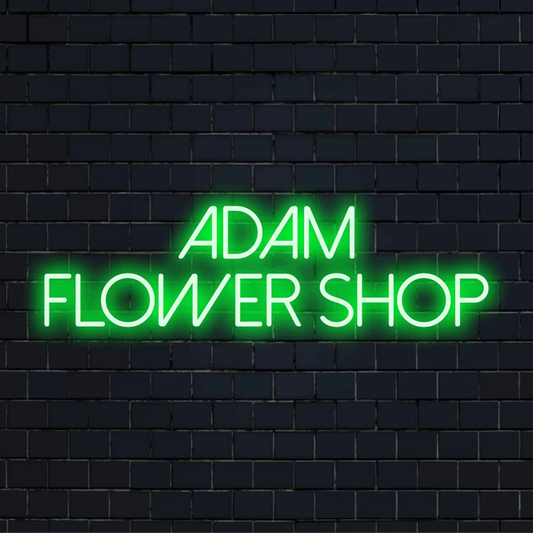 Adam Flower Shop Custom Name Neon Sign, bright neon glow on dark brick wall
