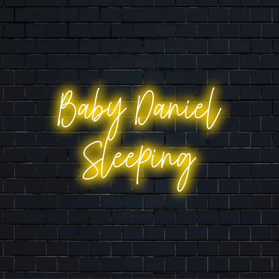 Baby Daniel Sleeping Personalized LED Neon Sign, bright neon glow against brick backdrop