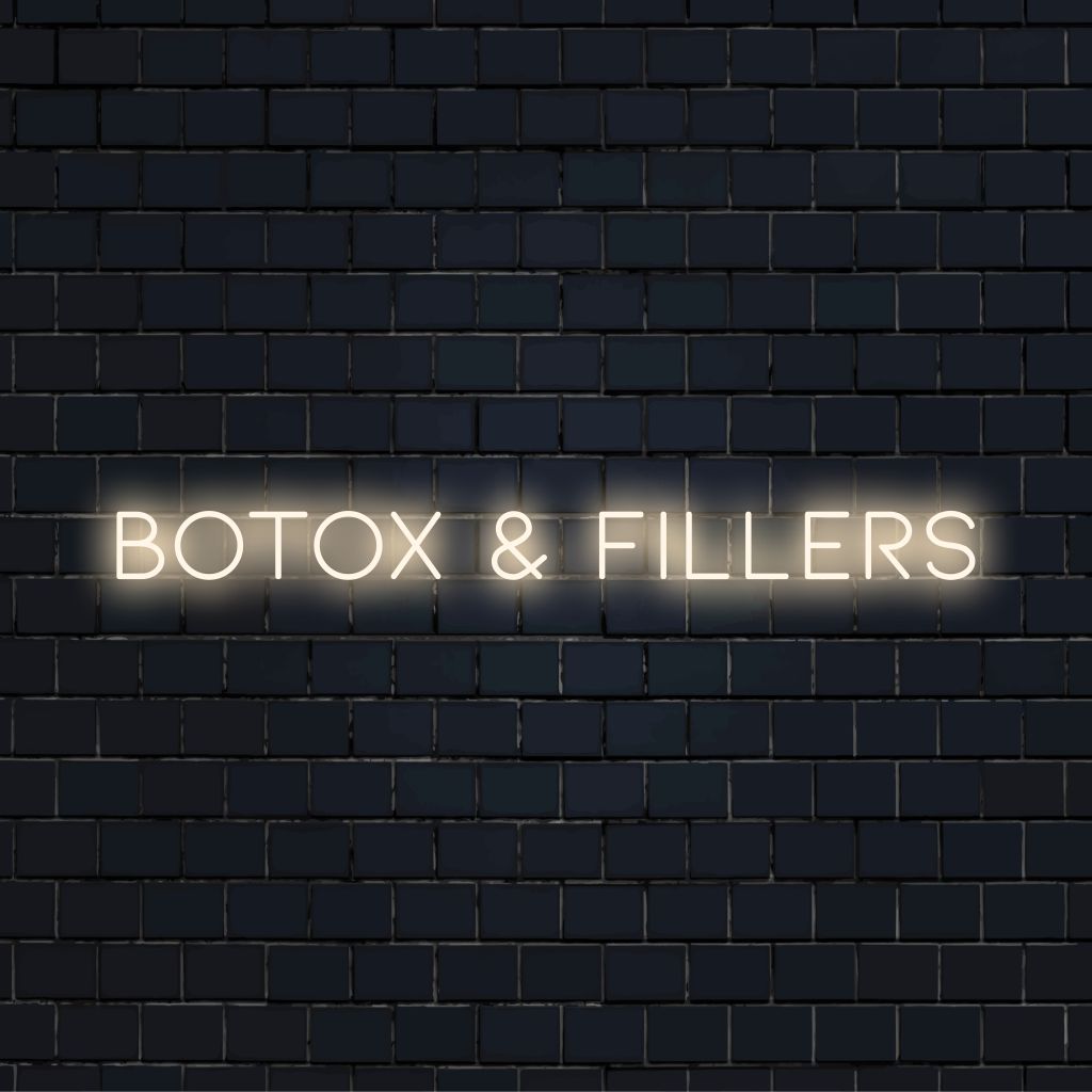 Botox Fillers Neon Sign, bright neon glow against black brick wall