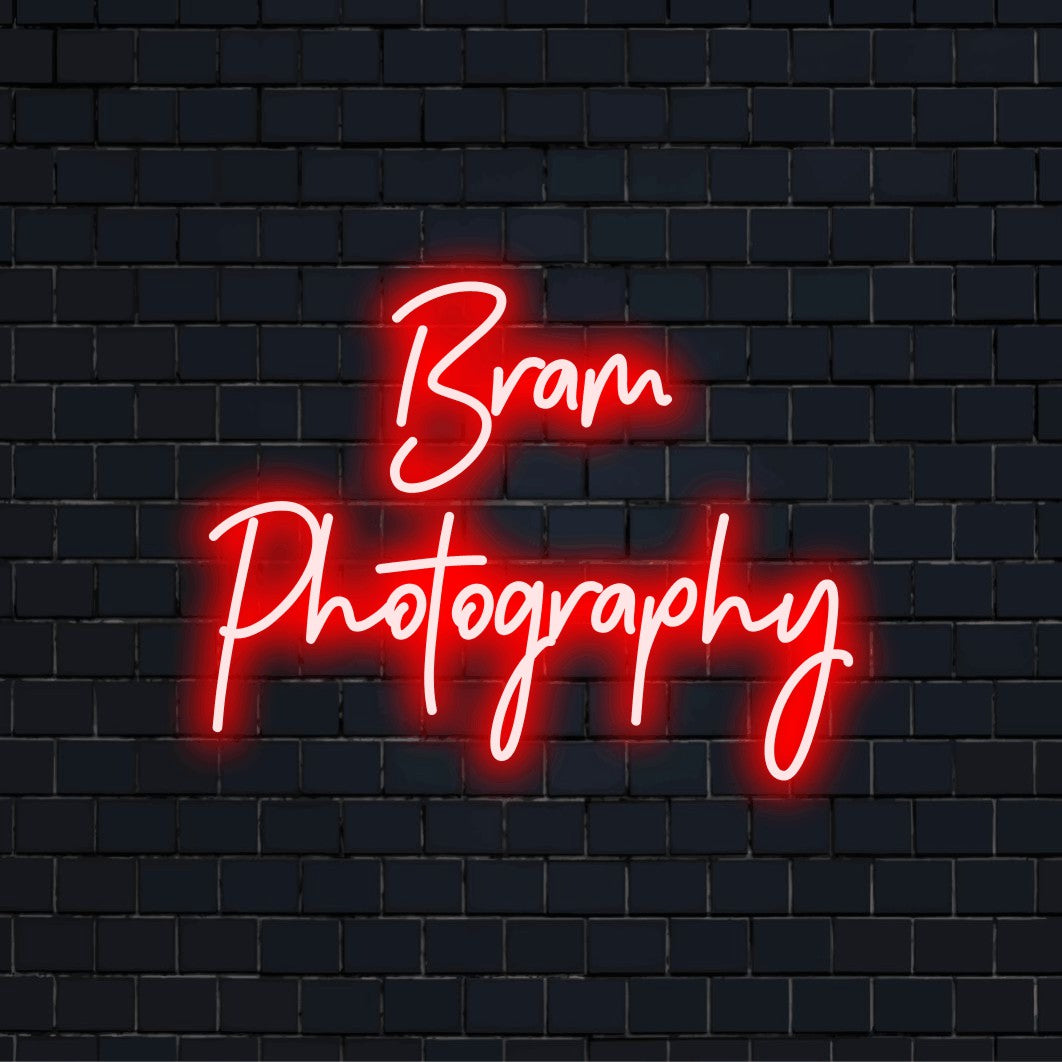 Bram Photography Custom Name Neon Sign, neon text light against brick backdrop