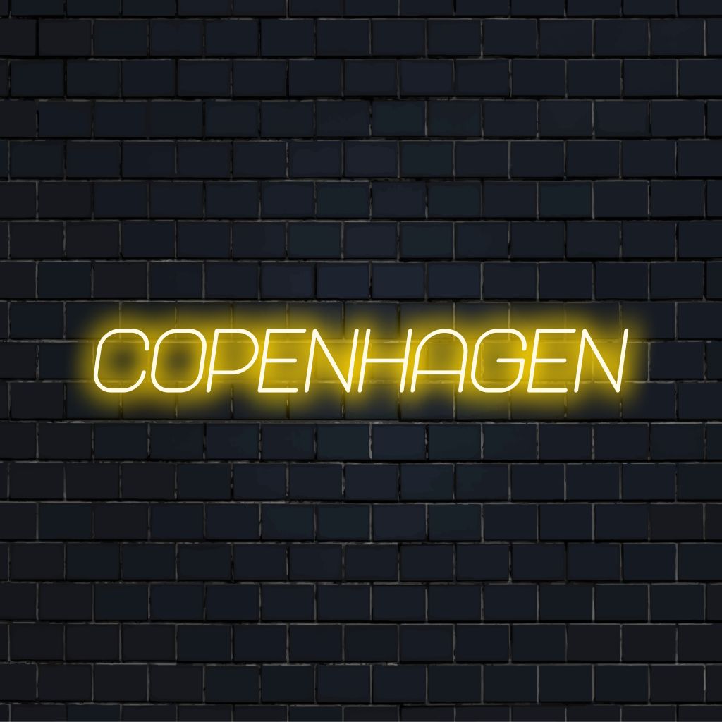 Copenhagen Neon Light with bright neon glow against brick backdrop