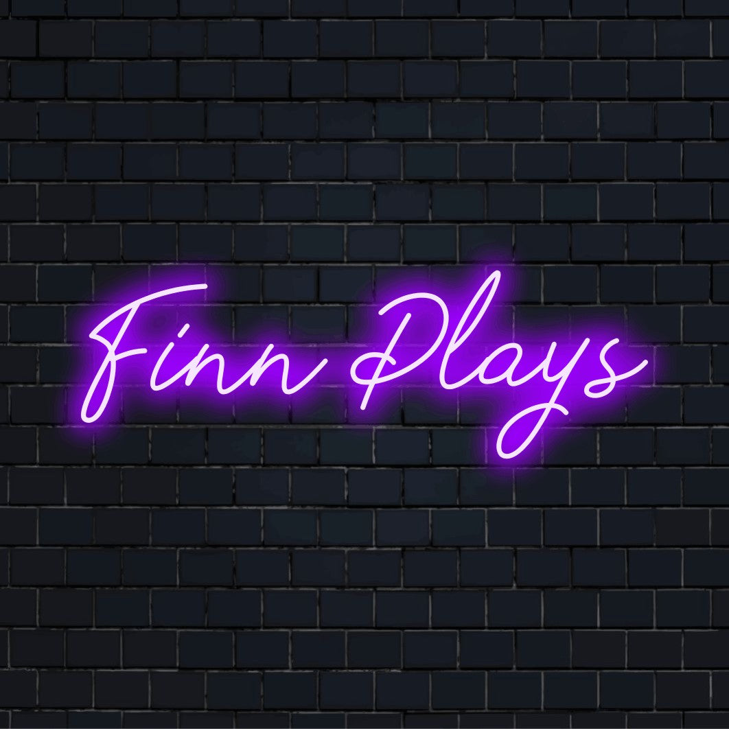 Finn Plays Custom Name Neon Sign, bright LED glow on dark brick background