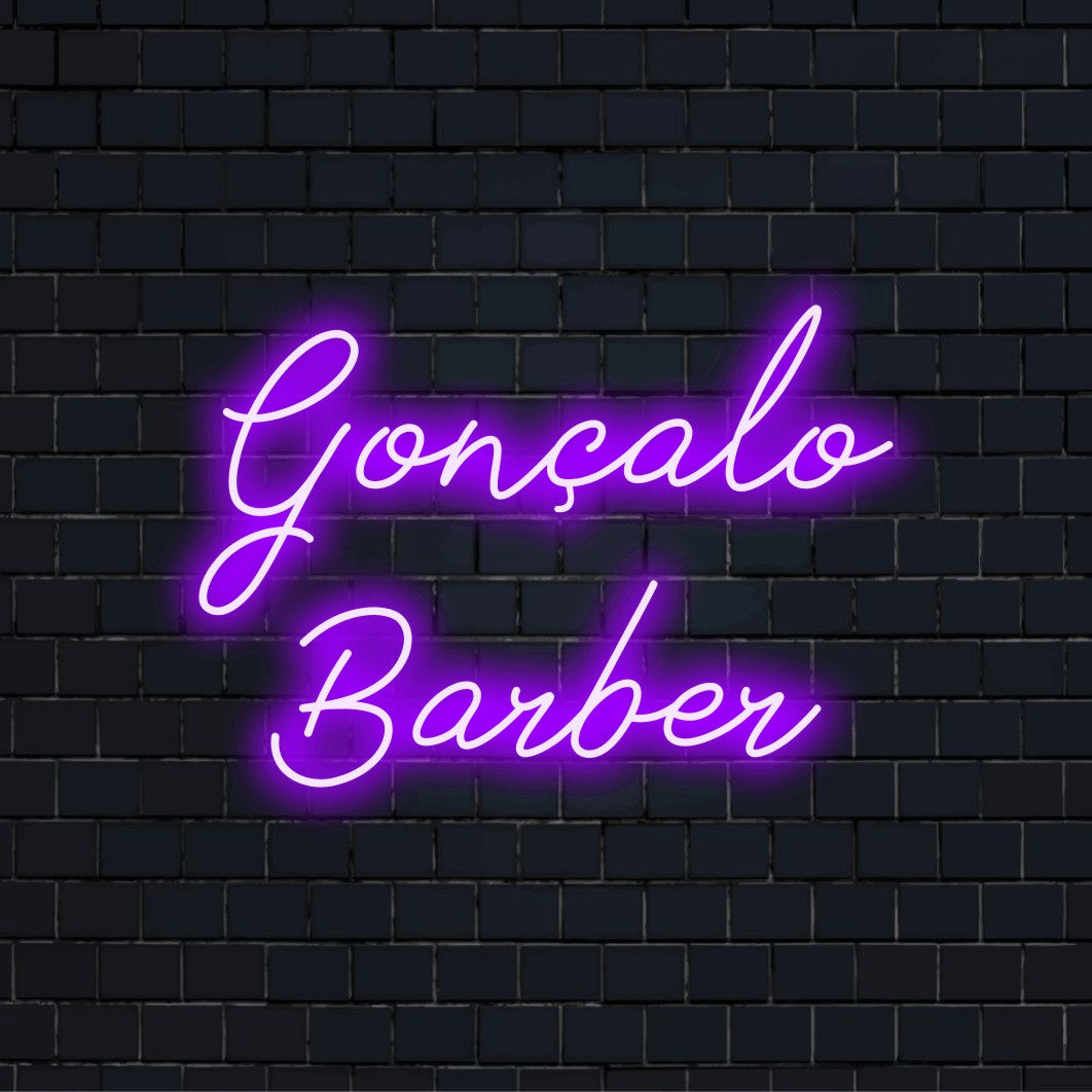 Goncalo Barber Custom Name Neon Sign, glowing neon text against black brick wall