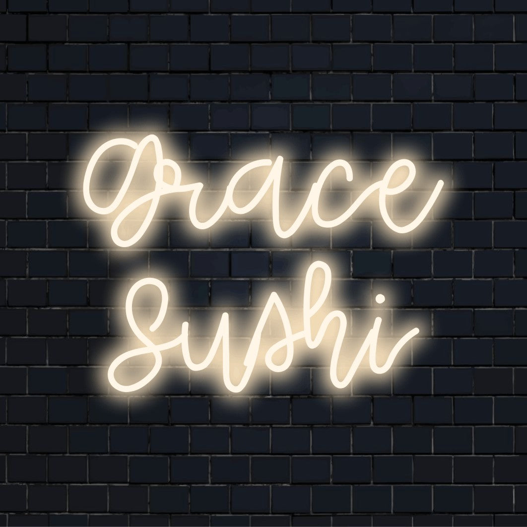 Grace Sushi Personalized Neon Light with glowing neon text on black brick background