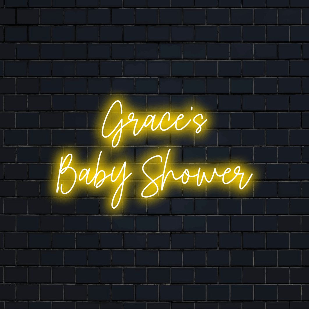 Grace_s Baby Shower Personalized Neon Light with bright neon lettering on dark brick wall