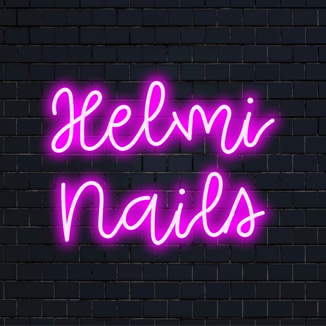 Helmi Nails Personalized Neon Light with glowing lettering against black brick wall
