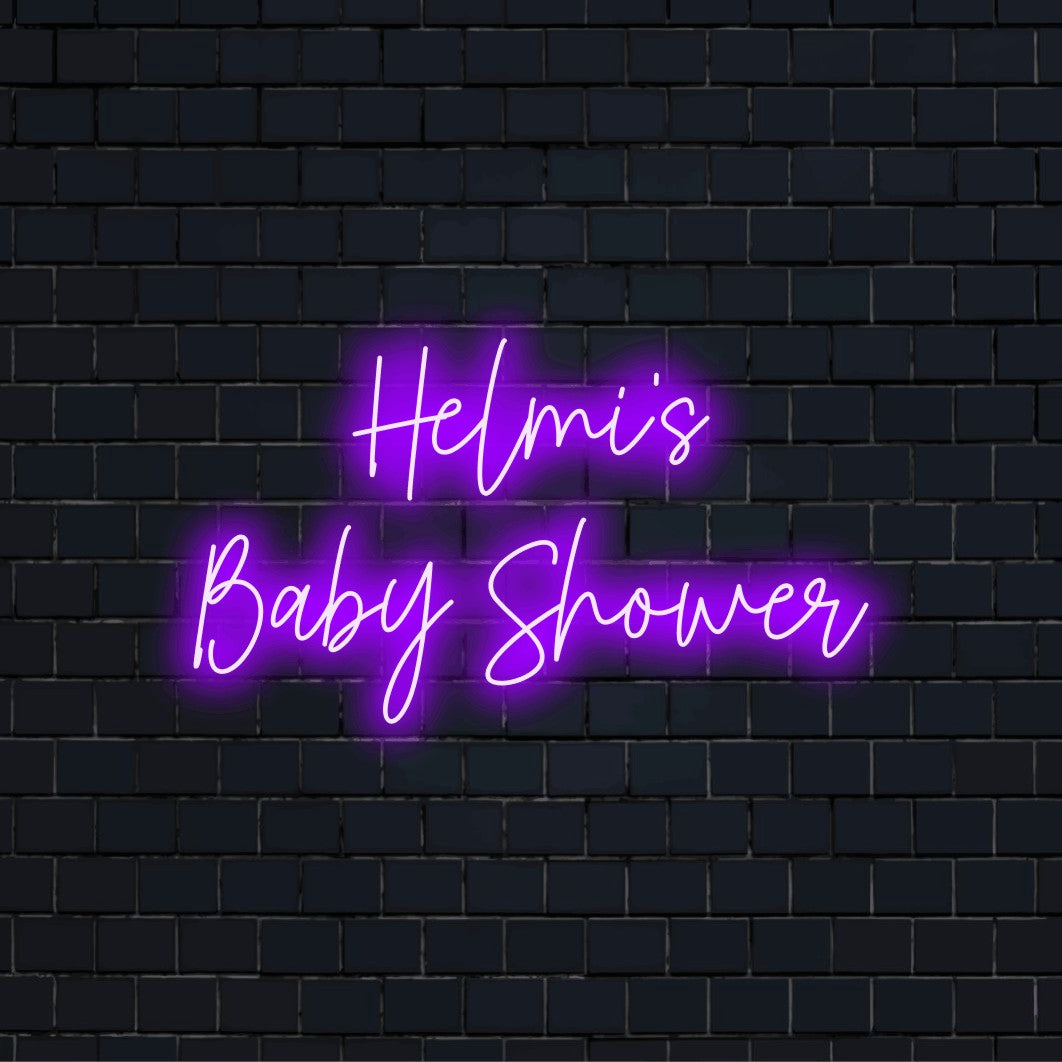 Helmi_s Baby Shower Personalized LED Neon Sign, soft neon glow against black brick wall