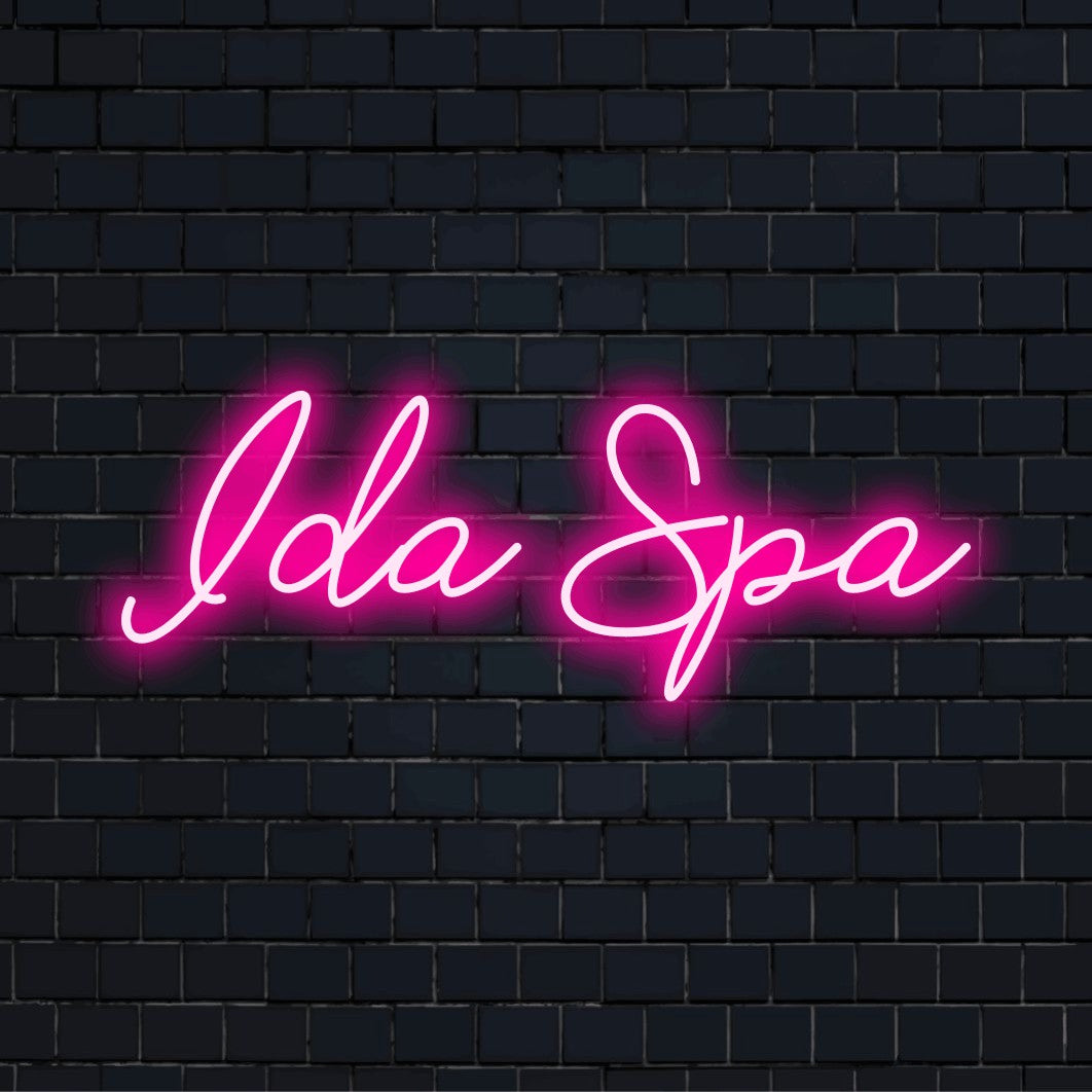 Ida Spa Personalized LED Neon Sign, glowing wall decor on dark brick background
