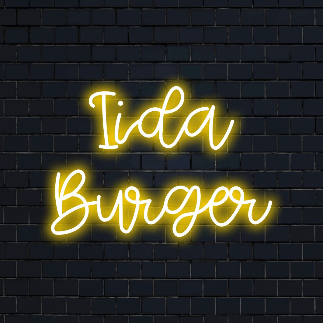 Iida Burger Custom Name Neon Sign, bright neon glow on dark brick wall