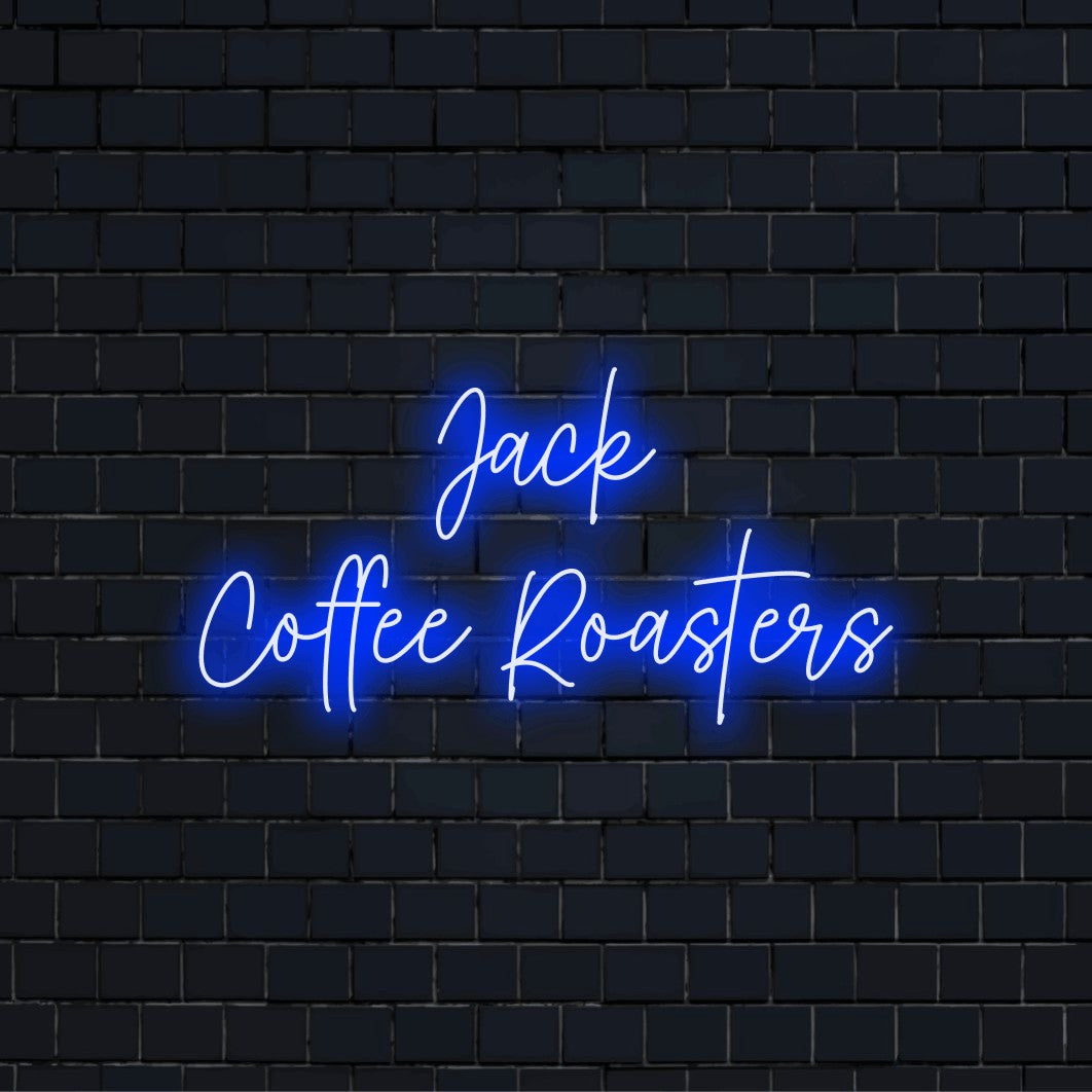 Jack Coffee Roasters Custom Name Neon Sign, neon text light against brick backdrop