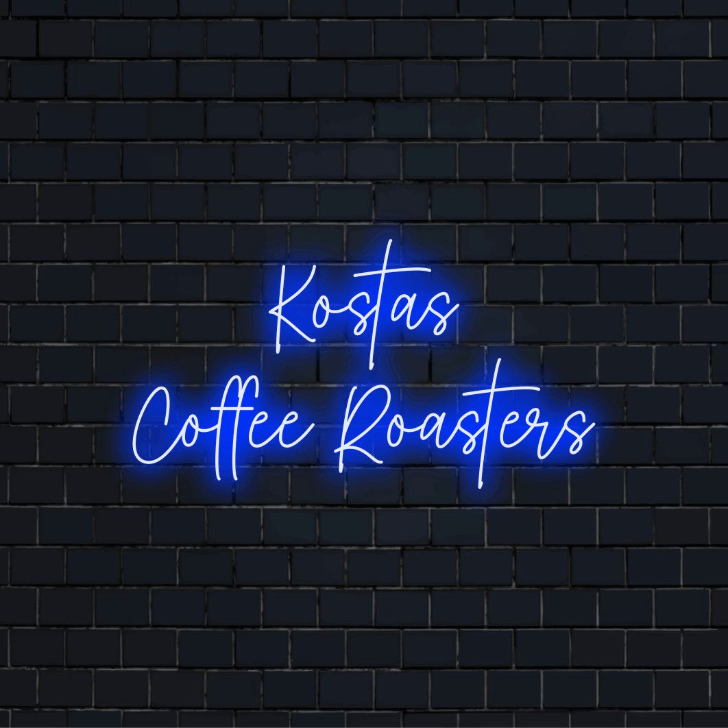 Kostas Coffee Roasters Custom Name Neon Sign, bright neon lettering against brick backdrop
