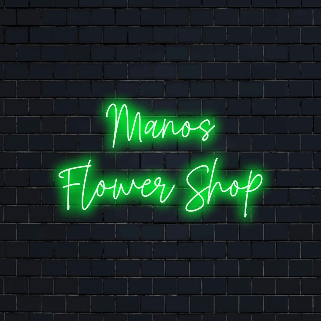 Manos Flower Shop Personalized LED Neon Sign, bright neon glow against black brick wall