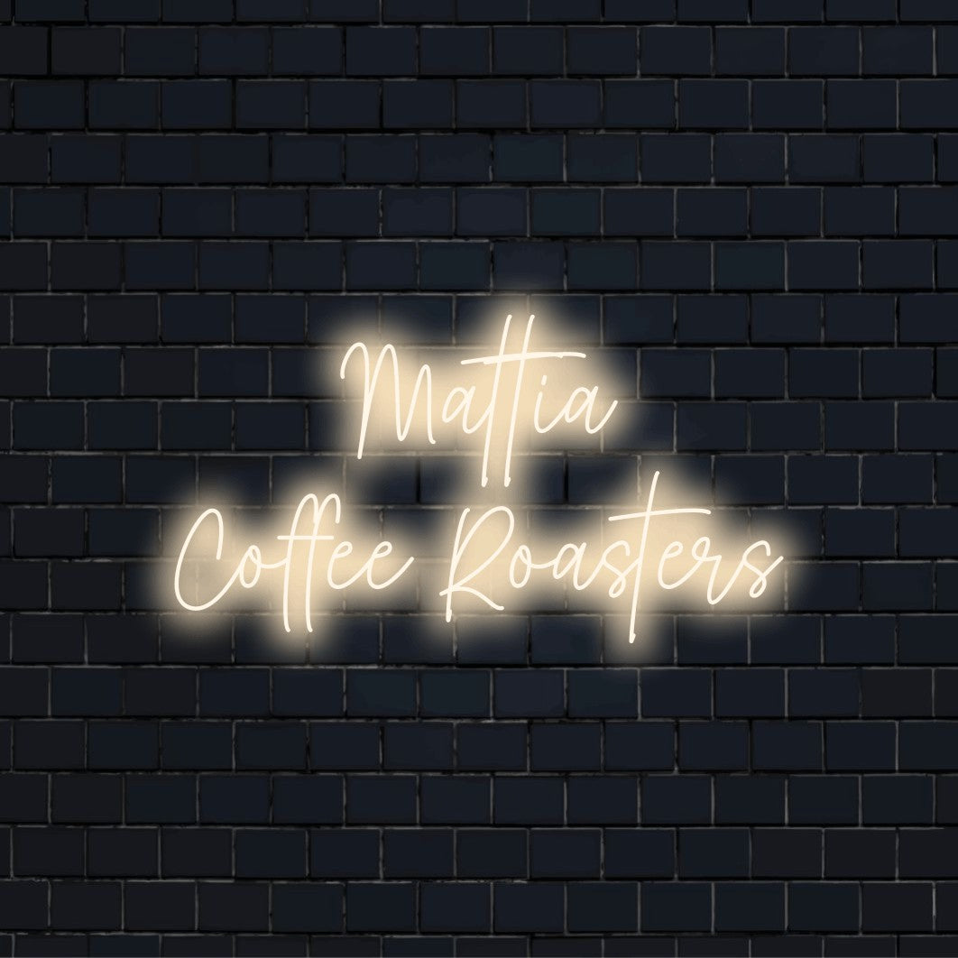 Mattia Coffee Roasters Personalized LED Neon Sign, glowing neon text against black brick wall