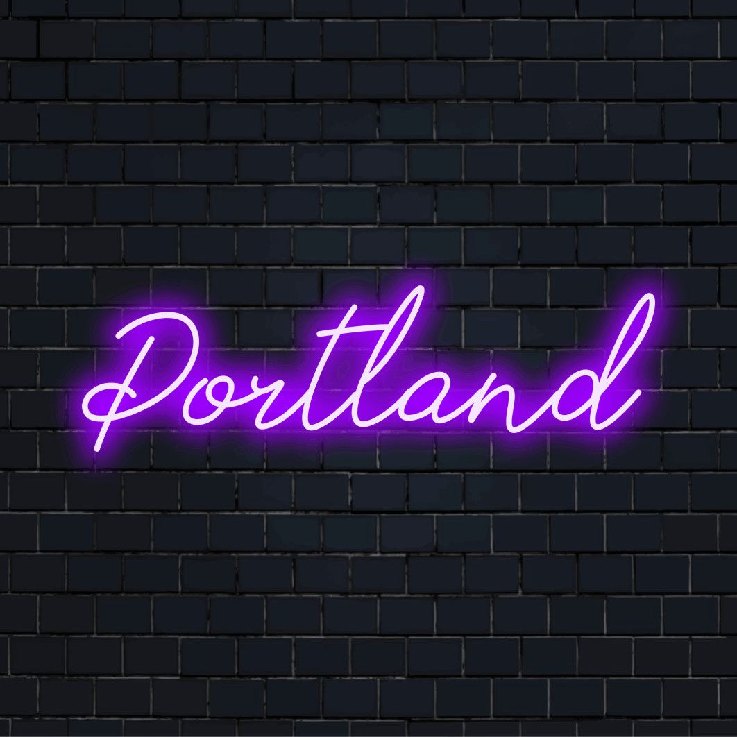 Portland Neon Sign, glowing neon text against brick backdrop