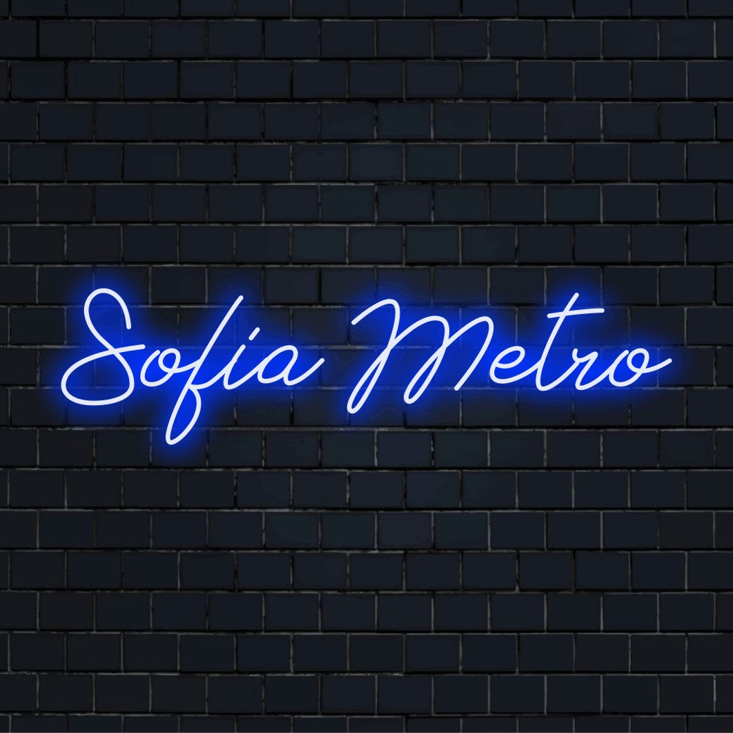 Sofia Metro Neon Light with bright neon lettering against brick backdrop