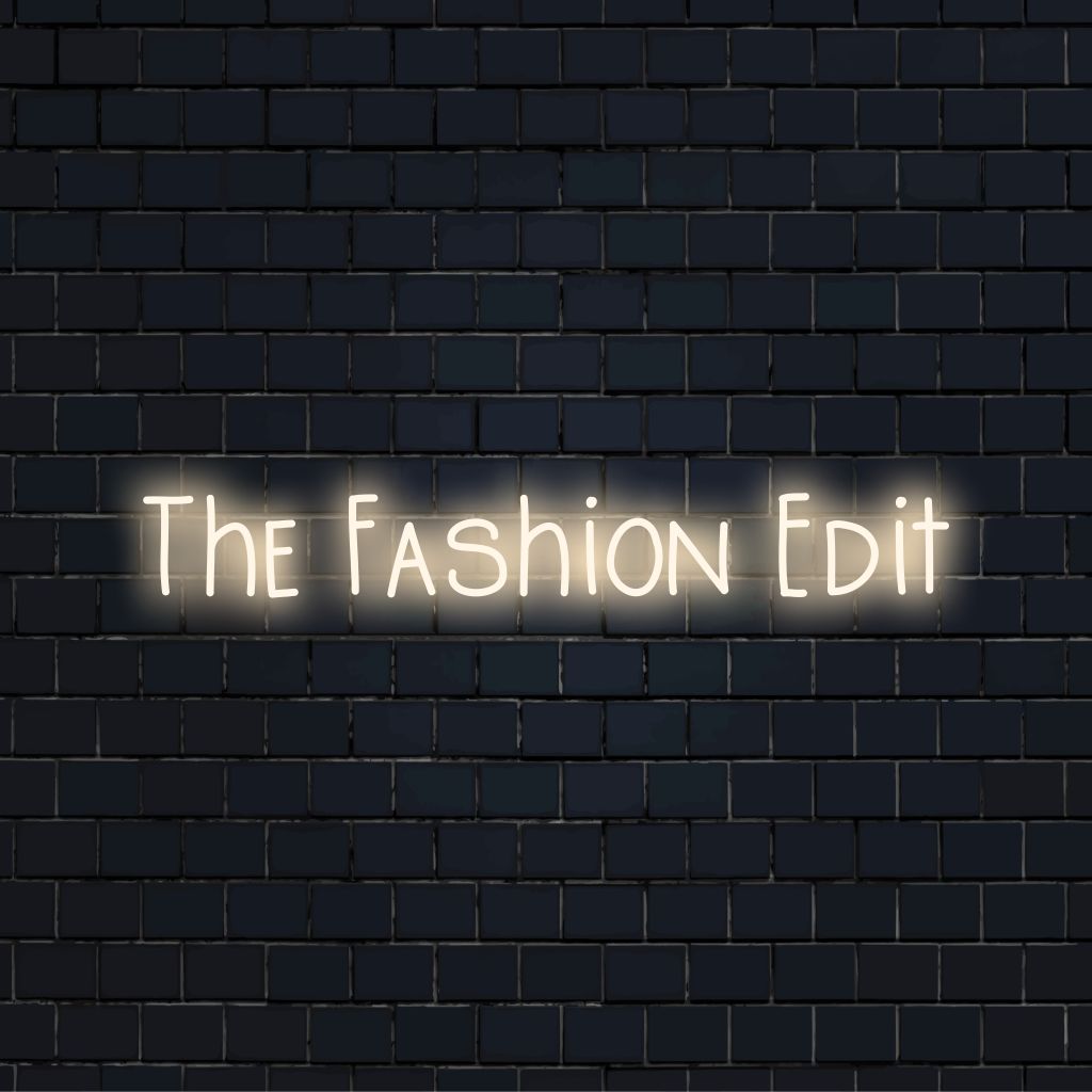 The Fashion Edit LED Neon Sign, soft neon glow on black brick background