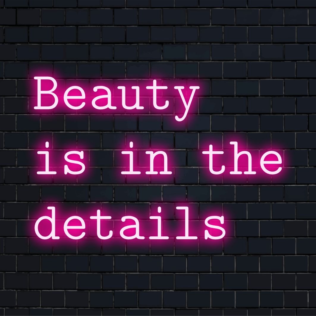 Placa de neon LED personalizada com os dizeres "A beleza está nos detalhes", perfeita para personalizar qualquer espaço com um toque vibrante e artístico.