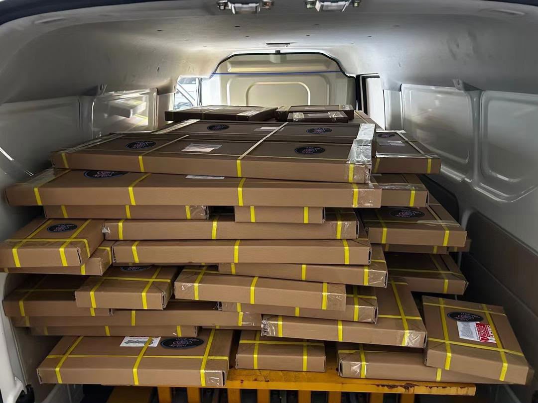 Multiple The Art Neon orders packed together in a delivery vehicle