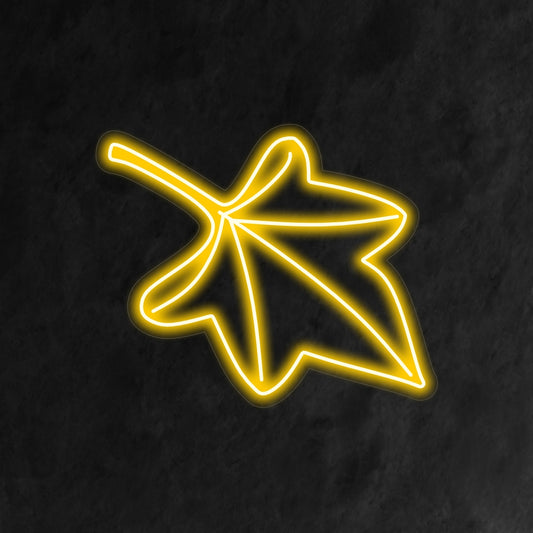 "Fall Leaf Neon Sign" lights up with warm autumn hues, perfect for seasonal decor and spaces celebrating the beauty of fall.