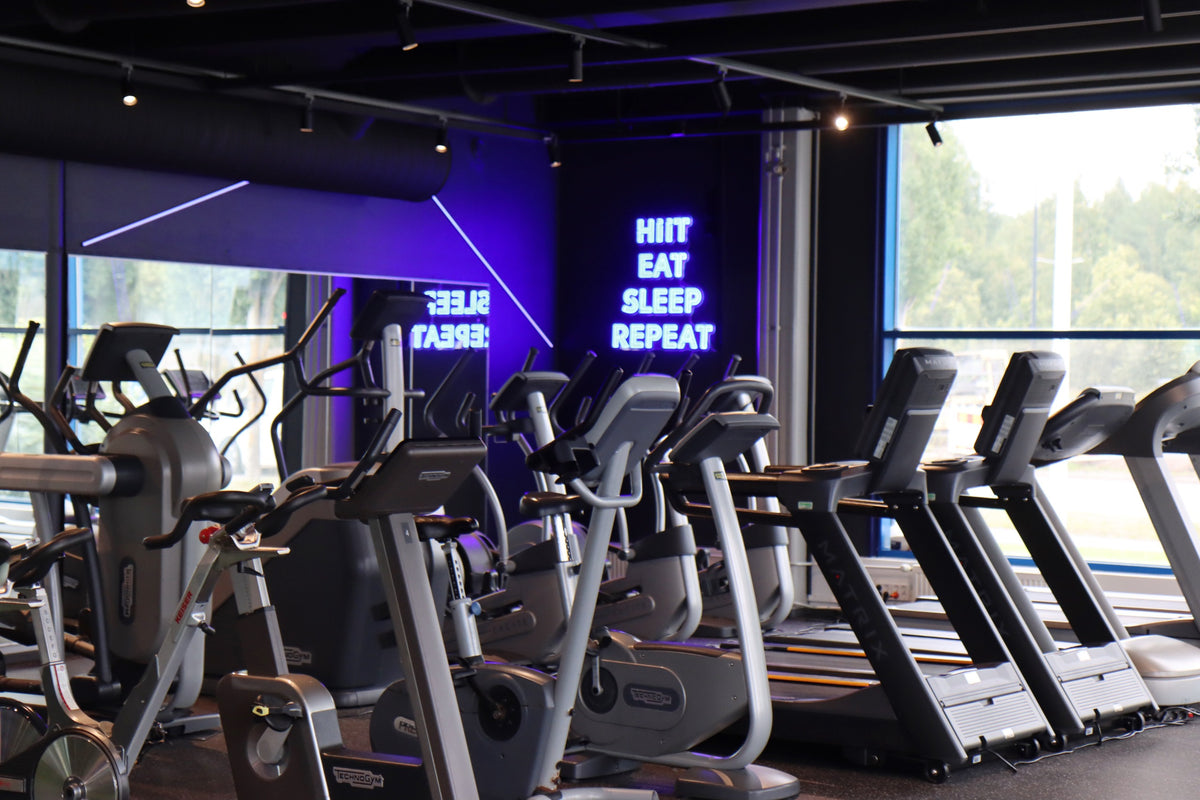 Blue custom LED neon sign installed in a gym