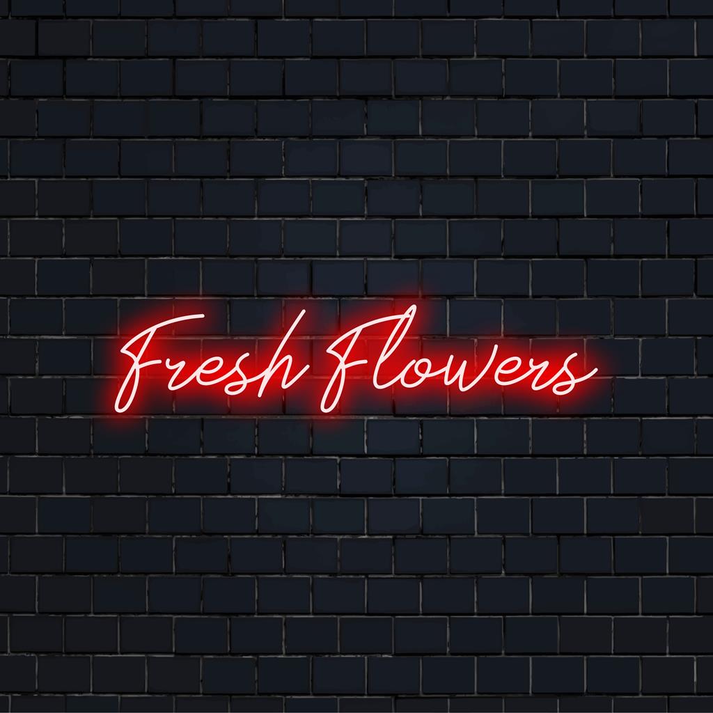Placa de neon iluminada com flores frescas, exibindo letras de LED brilhantes personalizadas, perfeita para decoração de interiores com neon vibrante.