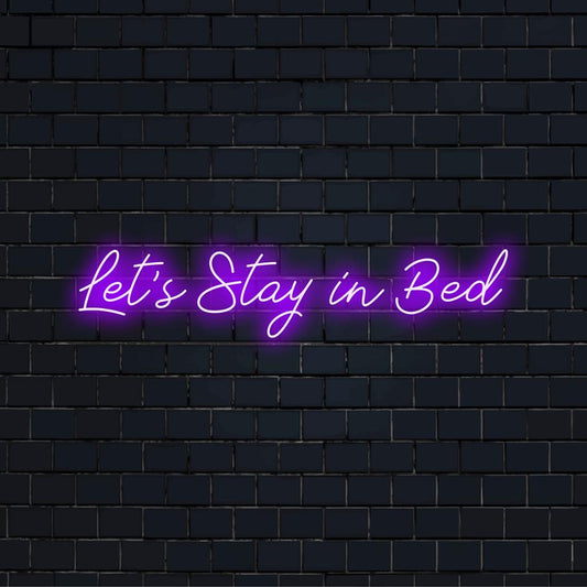 Handcrafted LED neon sign reading Let's Stay In Bed, perfect for cozy interior decor. Vibrant and inviting light piece.