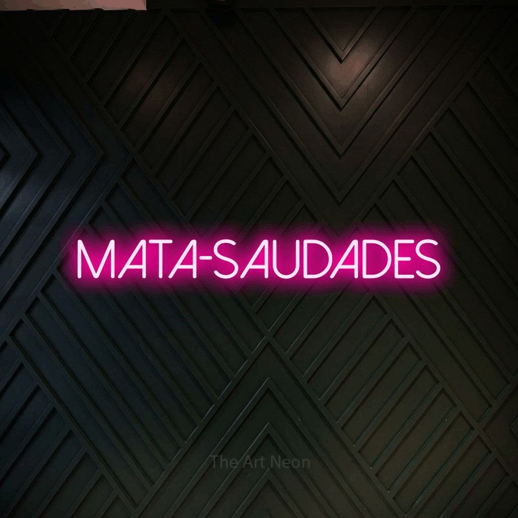 LED neon sign reading “MATA-SAUDADES”, arranged in a single line.