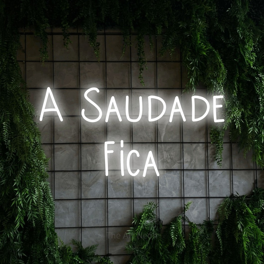 LED neon sign reading “A Saudade Fica”, arranged in 2 lines.