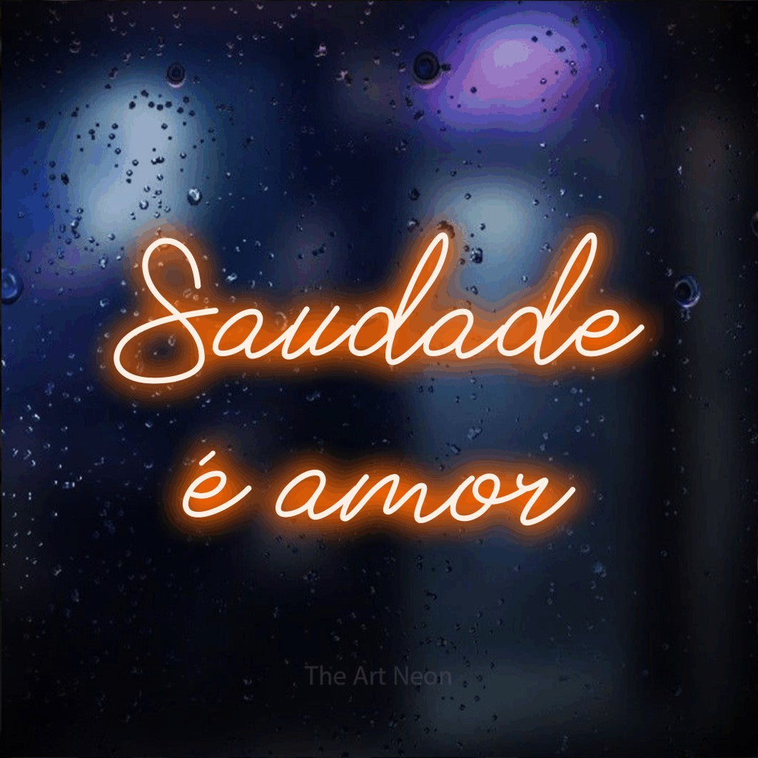 LED neon sign reading “Saudade é amor”, arranged in 2 lines.