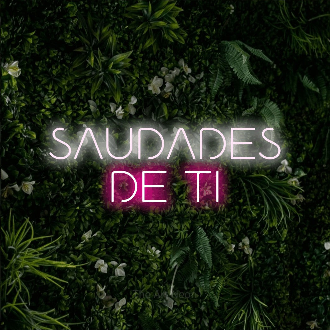 LED neon sign reading “SAUDADES DE TI”, arranged in 2 lines.