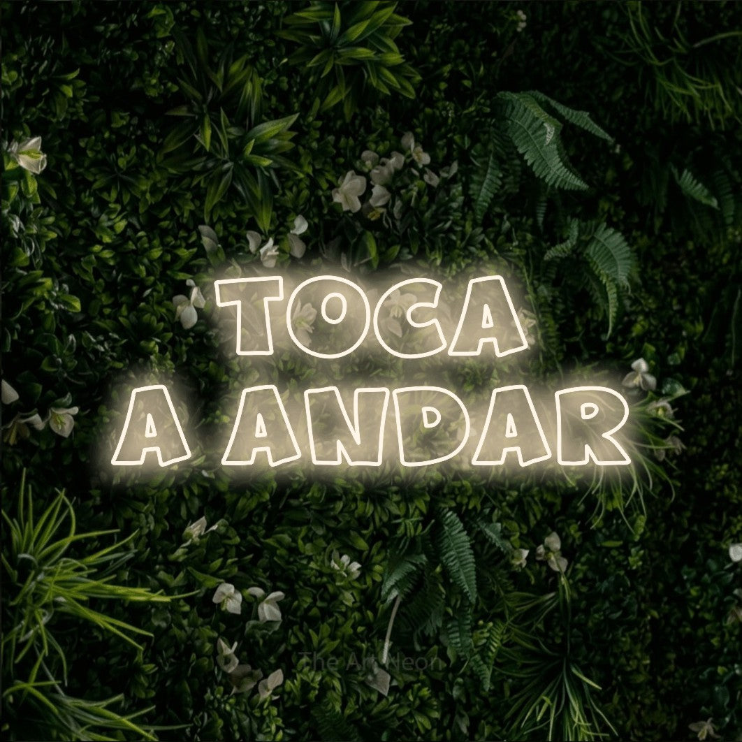 LED neon sign reading “toca a andar”, arranged in 2 lines.