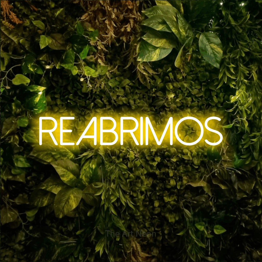 LED neon sign reading “REABRIMOS”, arranged in a single line.