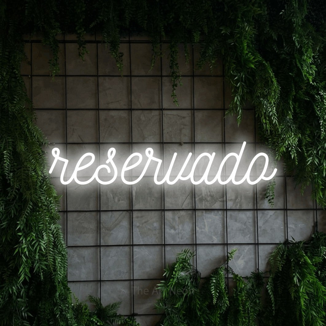 LED neon sign reading “reservado”, arranged in a single line.