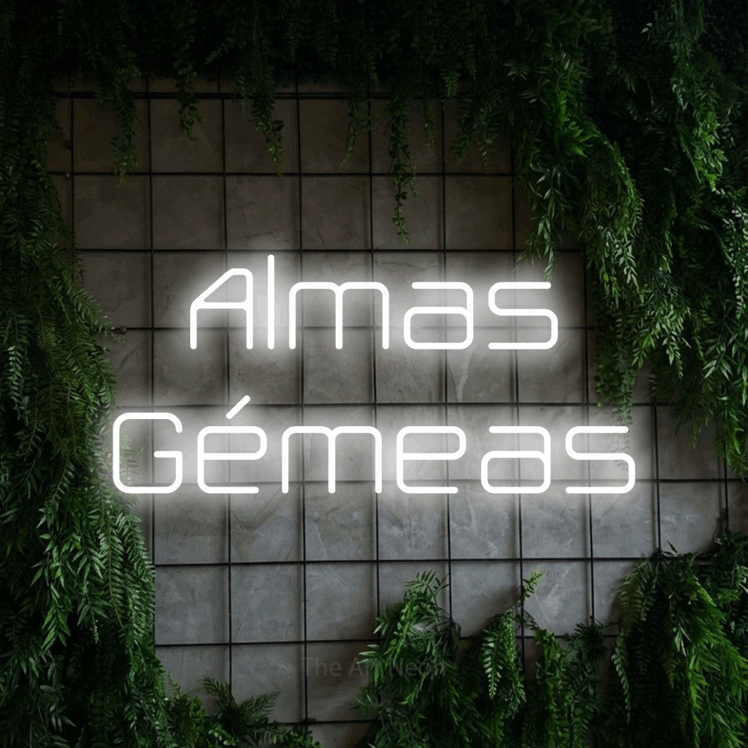 LED neon sign reading “Almas Gémeas”, arranged in 2 lines.