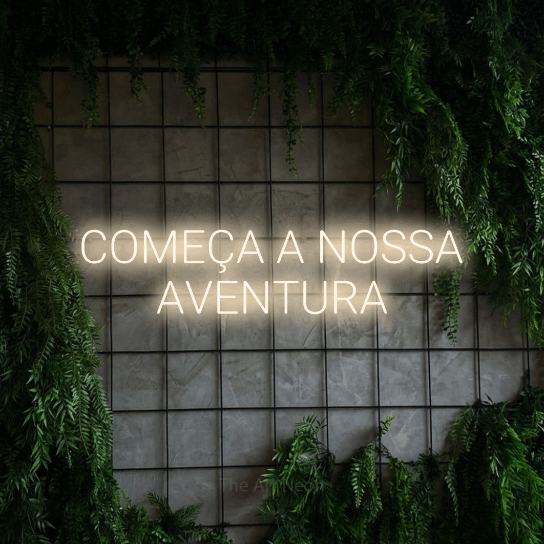 LED neon sign reading “COMEÇA A NOSSA AVENTURA”, arranged in 2 lines.