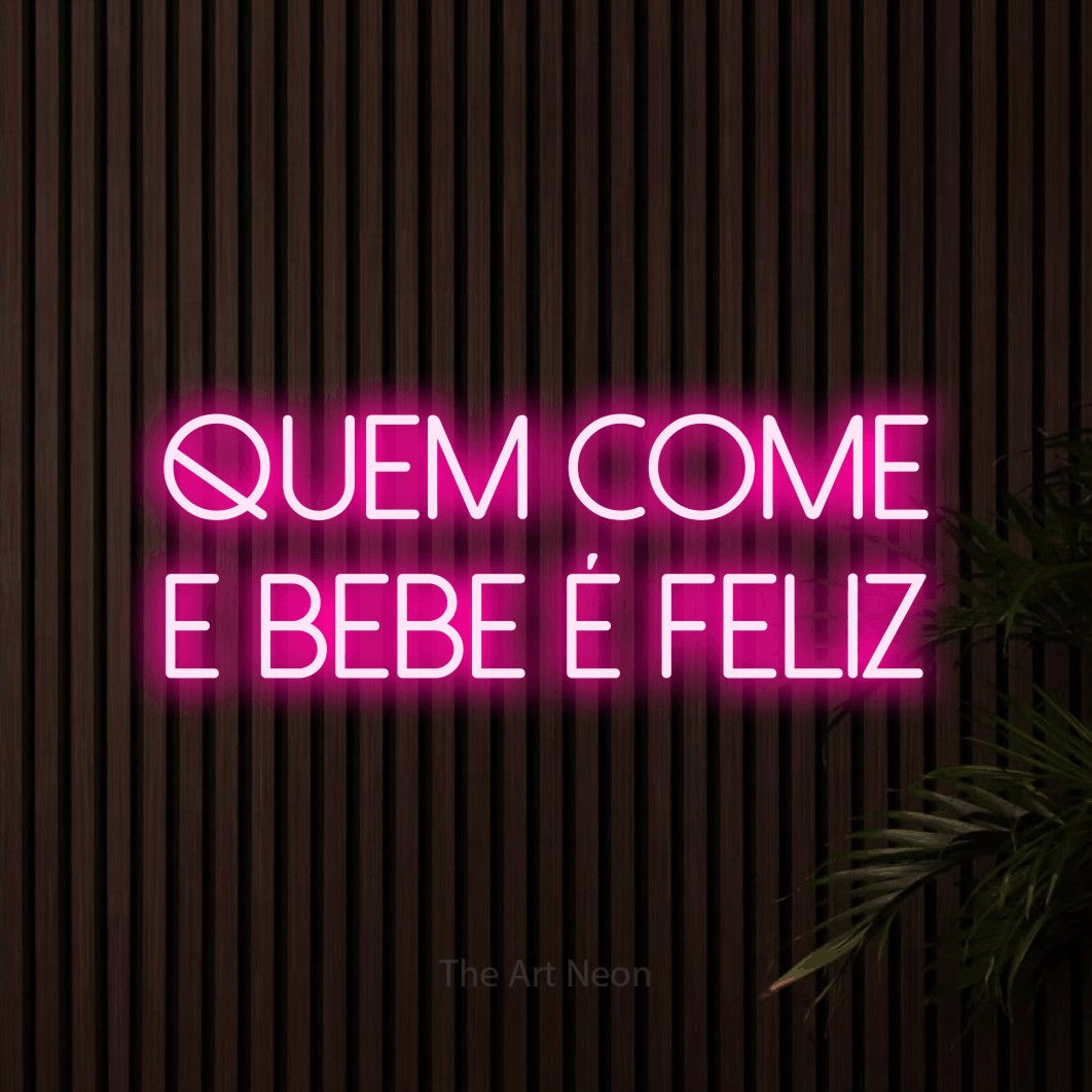 LED neon sign reading “quem come e bebe é feliz”, arranged in 2 lines.