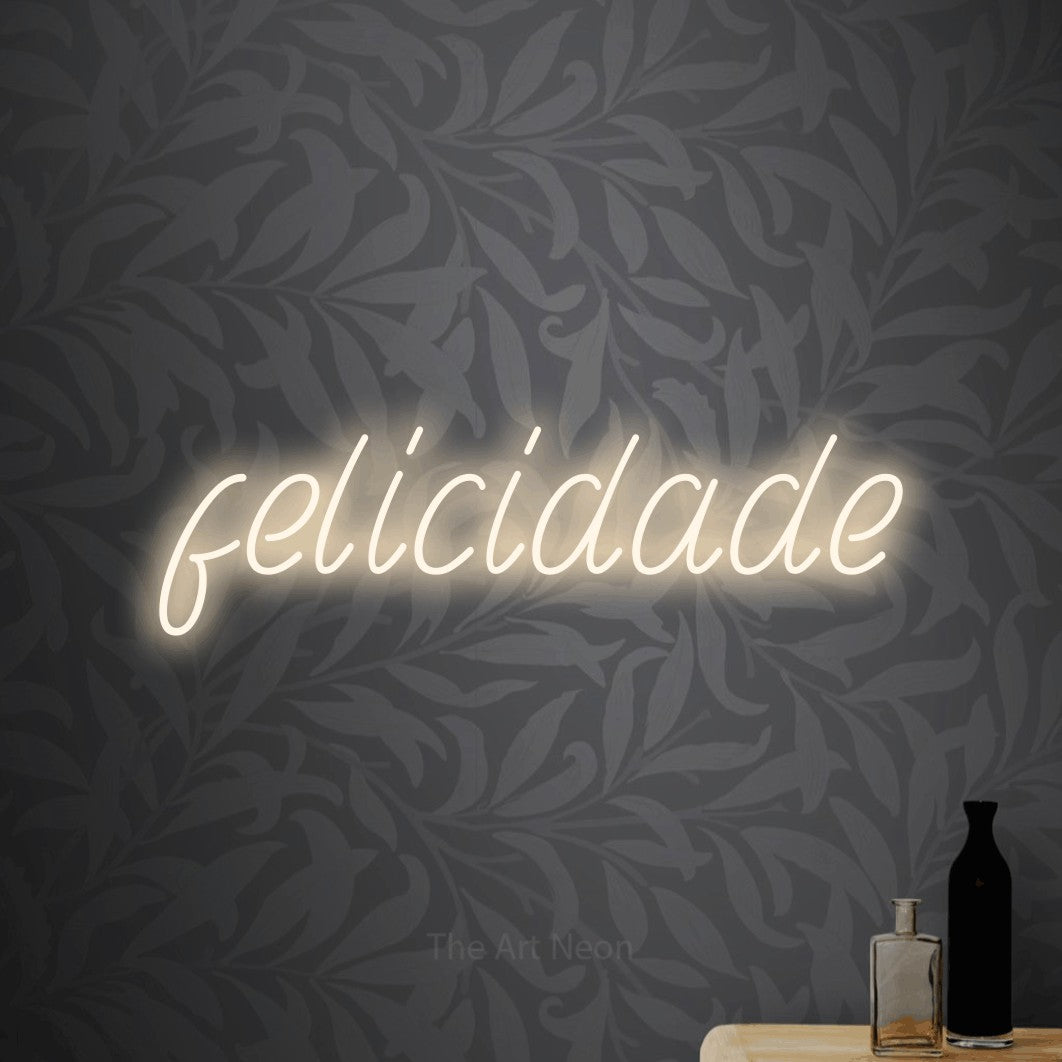 LED neon sign reading “felicidade”, arranged in a single line.