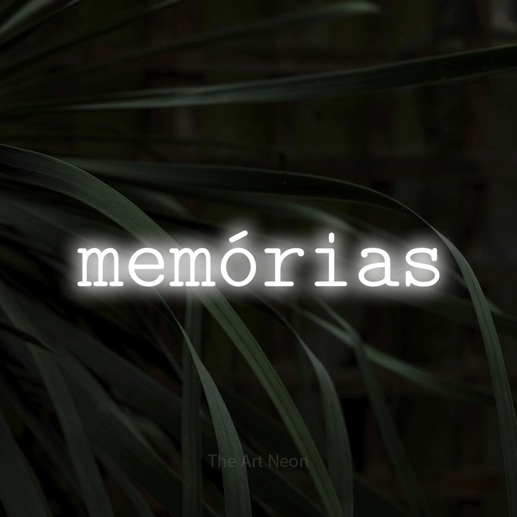LED neon sign reading “memórias”, arranged in a single line.