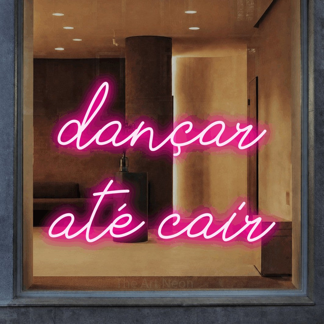 LED neon sign reading “dançar até cair”, arranged in 2 lines.