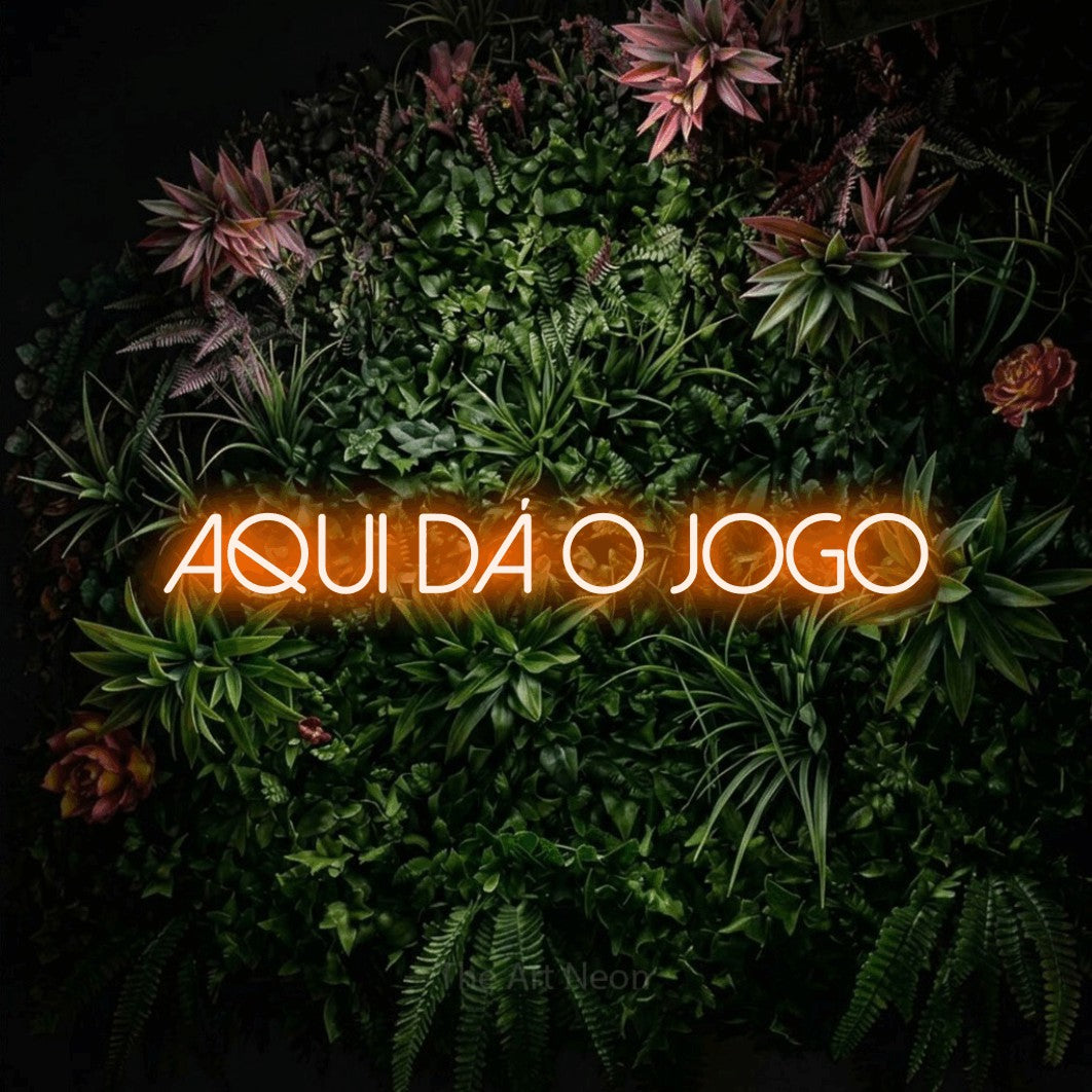 LED neon sign reading “aqui dá o jogo”, arranged in a single line.