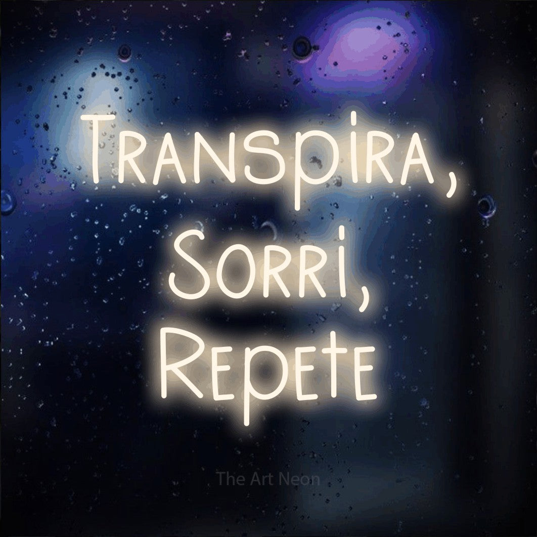 LED neon sign reading “Transpira, Sorri, Repete”, arranged in 3 lines.