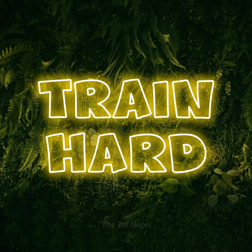 LED neon sign reading “train hard”, arranged in 2 lines.